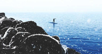 Image of a paddleboarder on the water
