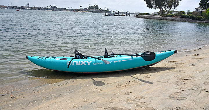 NIXY 2-person inflatable kayak on the shore of a beach
