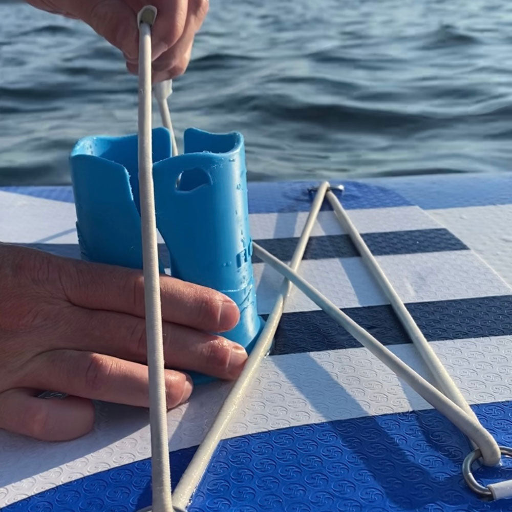 NIXY Floatsup paddle board cup holder being secured with a bungee cord