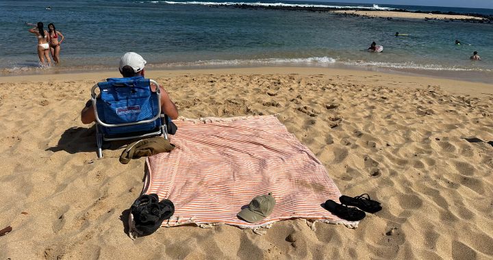 NIXY Mediterranean oversized Turkish cotton beach towel laying flat on the sand at the beach