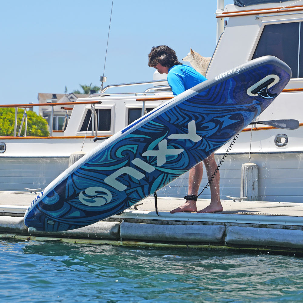 NIXY Monterey G5 Inflatable Stand-Up Paddleboard being lowered onto the water