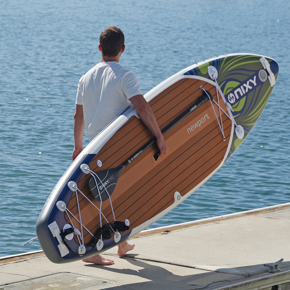 Paddler on a dock looking out to sea with Newport G5 Bora Bora inflatable paddle board
