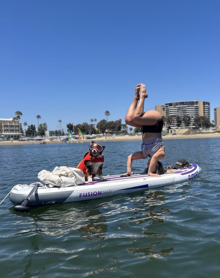 Woman paddling with her dog on a NIXY Inflatable Paddleboard