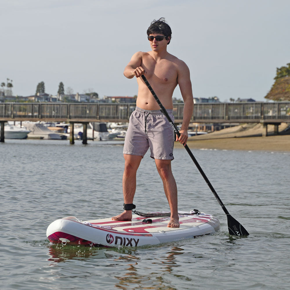 NIXY Venice G5 Cruiser / Yoga Paddle Board, man paddling a wide stable cruiser across a calm harbor