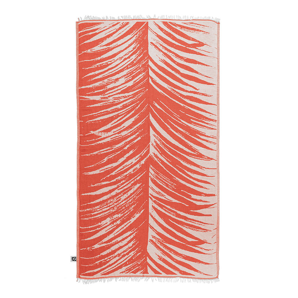 NIXY Palm Turkish Beach Towel in bright red, flat-woven Turkish cotton towel on the sand
