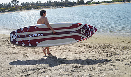 Beginner paddleboarding on the water for the first time