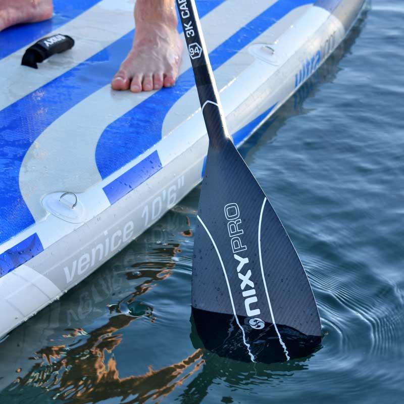 NIXY 3-Piece 3K Carbon Fiber SUP Pro Paddle in use on the water, adjustable carbon paddle