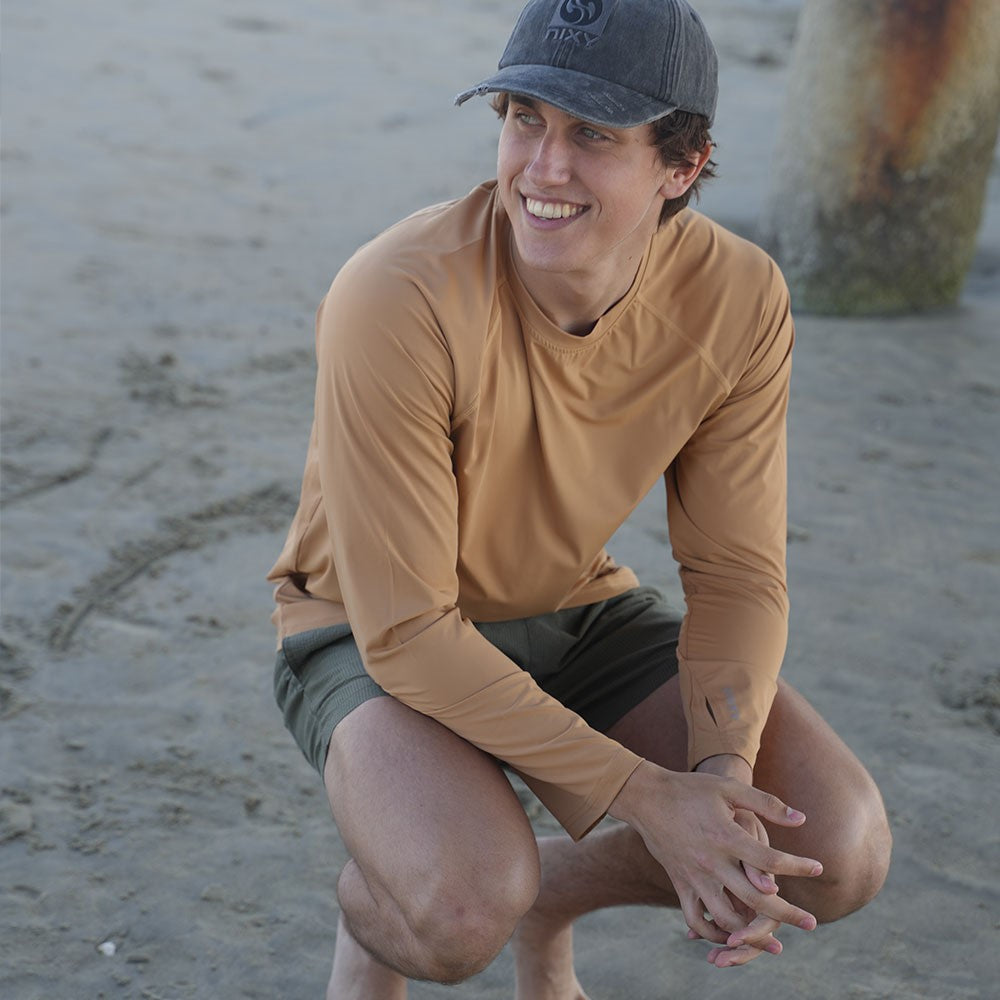 NIXY Men's Tan Brown Rash Guard UPF 50+ worn outdoors on the sand
