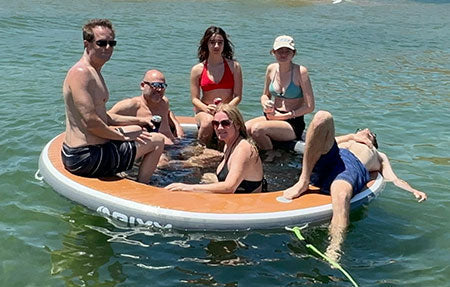 Lifestyle image of nixy inflatable water hammock on the water