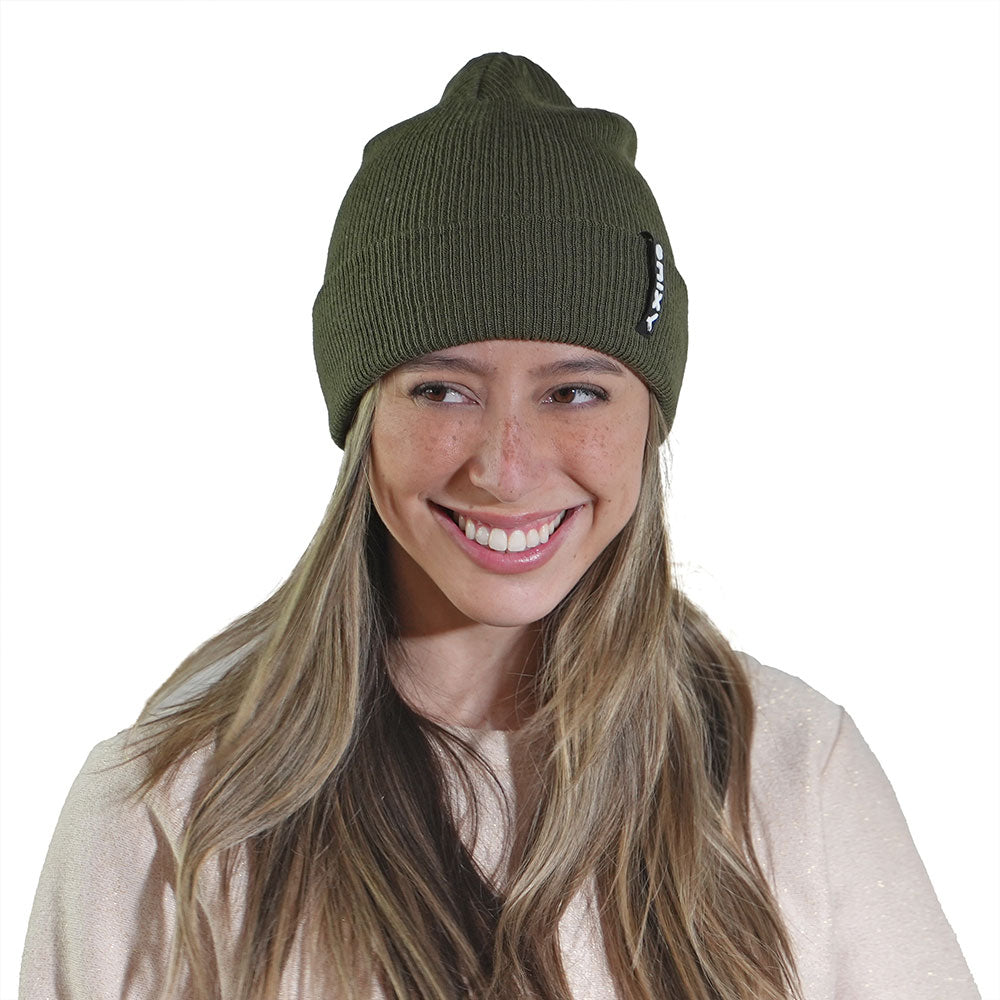 Smiling woman wearing earth green NIXY Sports classic cuffed knit beanie – ribbed unisex winter hat for men and women, perfect for outdoor adventures and cold-weather paddleboarding