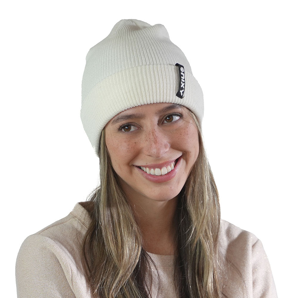 Smiling woman wearing pearl white NIXY Sports classic cuffed knit beanie – unisex winter hat for men and women, ideal for snow days, paddleboarding, and cold-weather outdoor sports