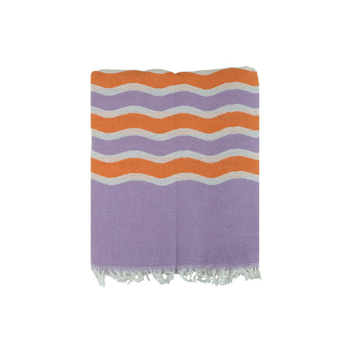 Striped Turkish cotton beach towel with orange, purple, and white pattern on a white background