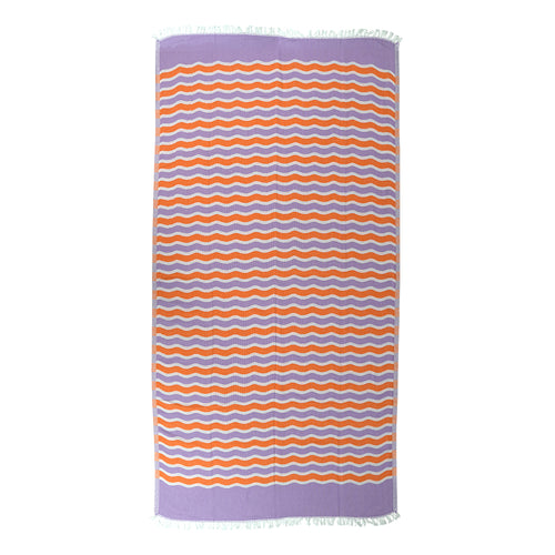 Turkish cotton beach towel with orange and purple wavy pattern on a white background