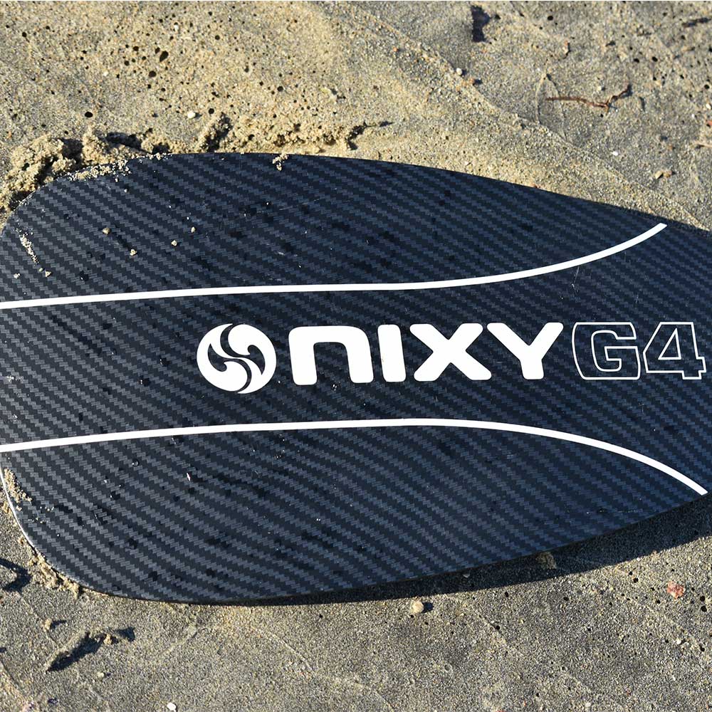Lightweight 3-piece hybrid carbon fiber paddle resting on the sand at the beach