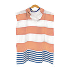 Landon Kids Turkish Cotton Poncho with orange, white, and blue striped pattern on a hanger against a white background