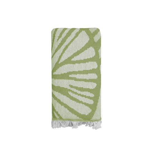 Green and white patterned Turkish cotton beach towel with frayed edges on a white background