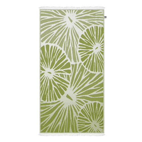 Green and white citrus patterned Turkish cotton towel on a white background