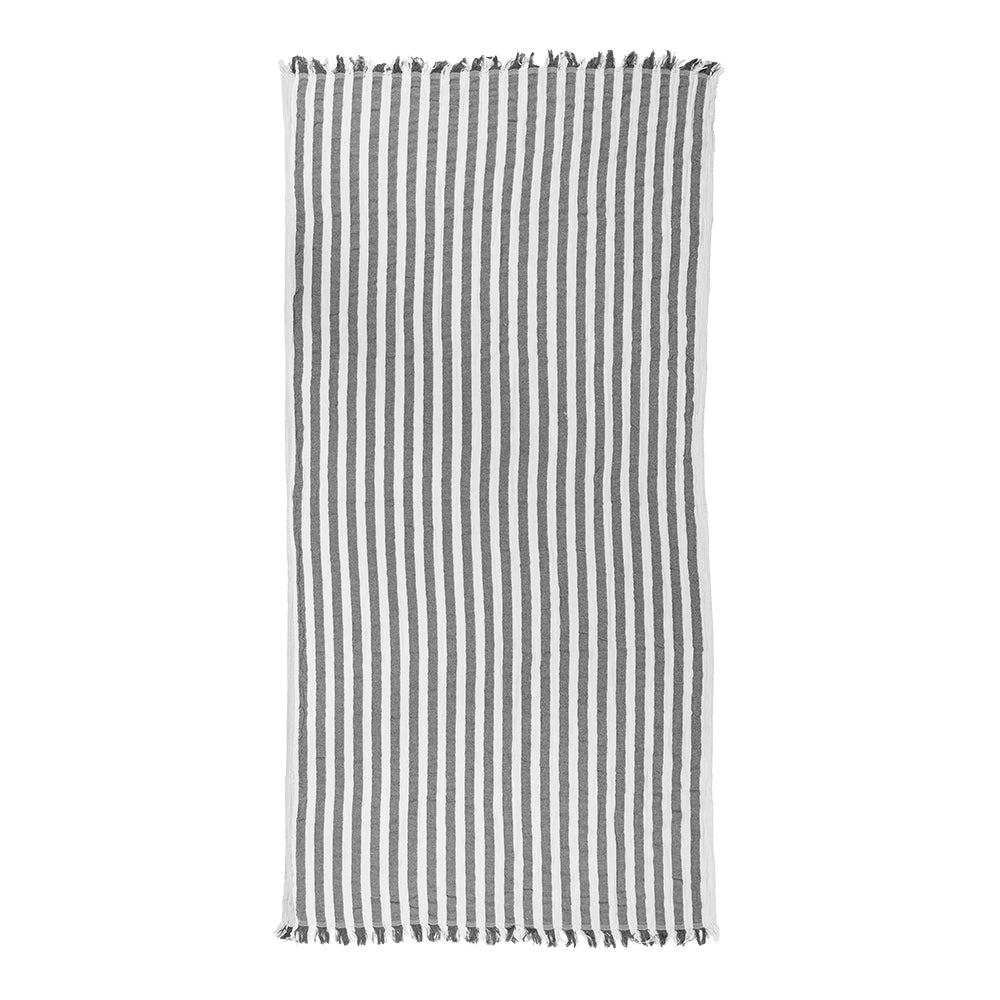 NIXY Melody recycled Turkish cotton beach towel with narrow vertical stripes on a white background and fringed edges, shown flat against a plain white backdrop.