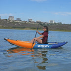 NIXY Tahoe 114 single rider inflatable kayak gliding on the water while a woman paddles