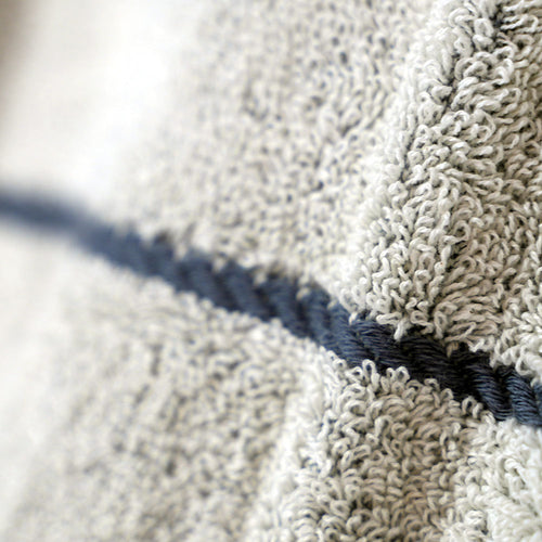 Close-up of NIXY Adult Turkish cotton changing poncho with a blue stripe