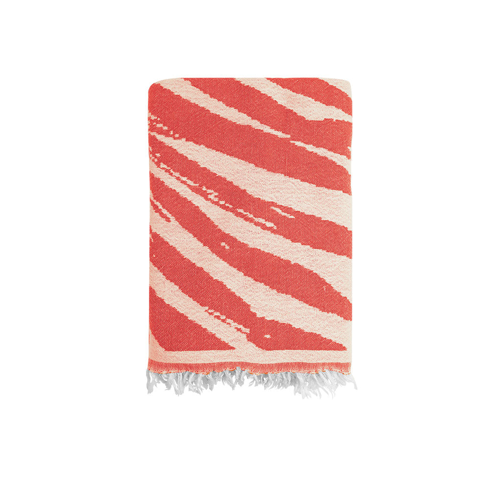 Close-up of the NIXY Palm Turkish Beach Towel in Bright Red, 100% Turkish cotton weave with palm-leaf print