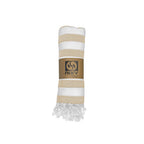 NIXY Acelia Bamboo Turkish Beach Towel in Beige rolled and styled on a white background