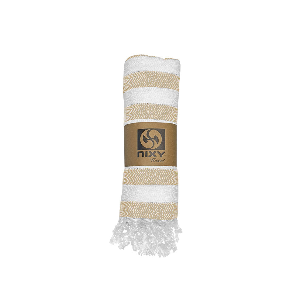 NIXY Acelia Bamboo Turkish Beach Towel in Beige rolled and styled on a white background