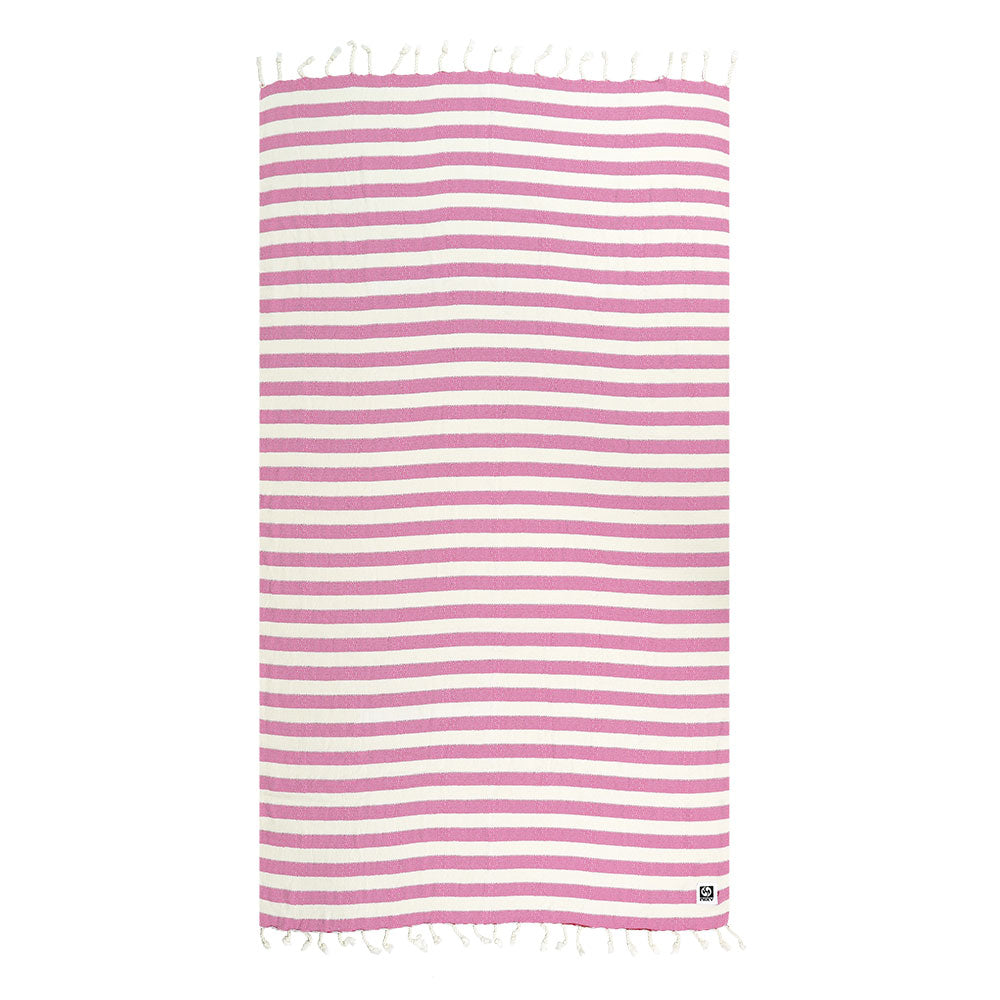 Striped Turkish cotton and bamboo beach towel with pink and white stripes on a white background