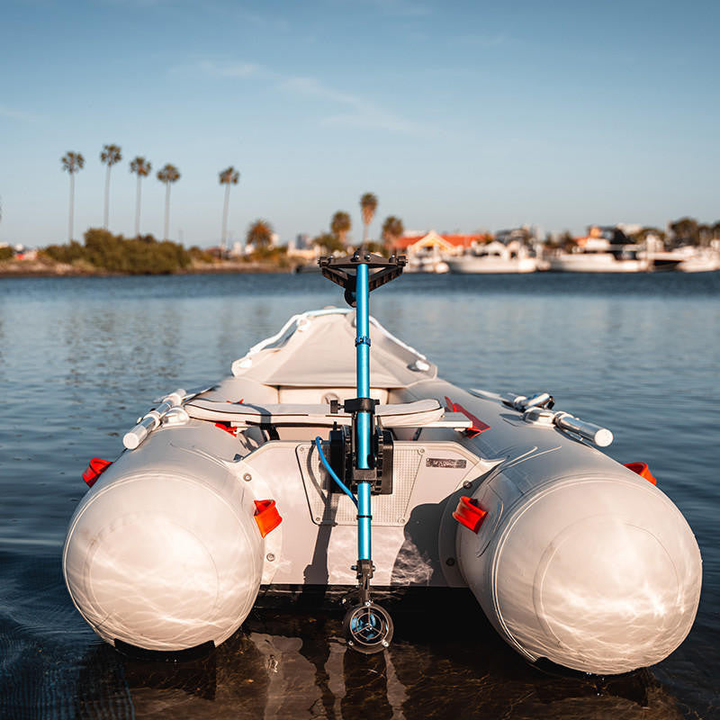 Inflatable boat with electric motor attached to the back. 