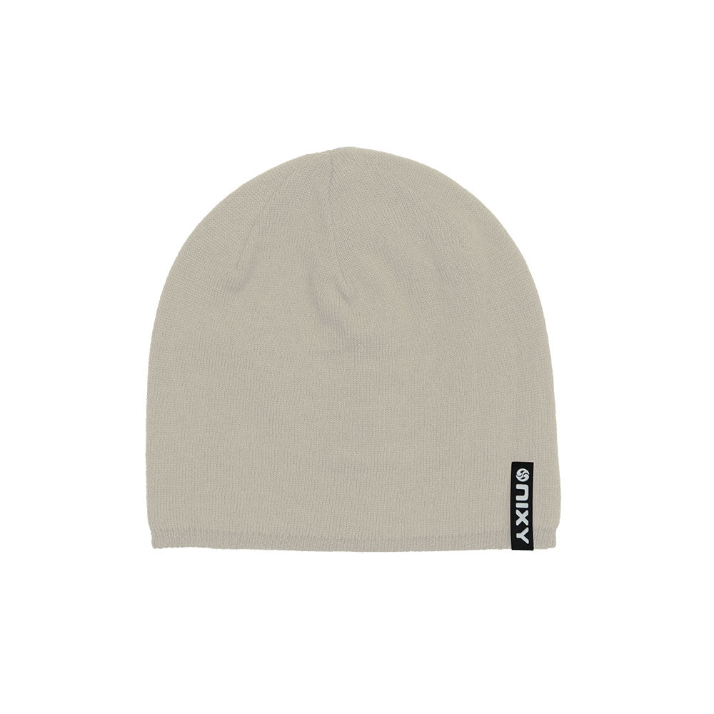 Beige cream NIXY Sports classic knit beanie – uncuffed slouchy unisex winter hat with woven logo label, neutral-tone product shot on white background