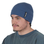 Young man wearing navy blue NIXY Sports classic cuffed knit beanie – men's winter hat for paddleboarding, fishing, and cold-weather outdoor sports