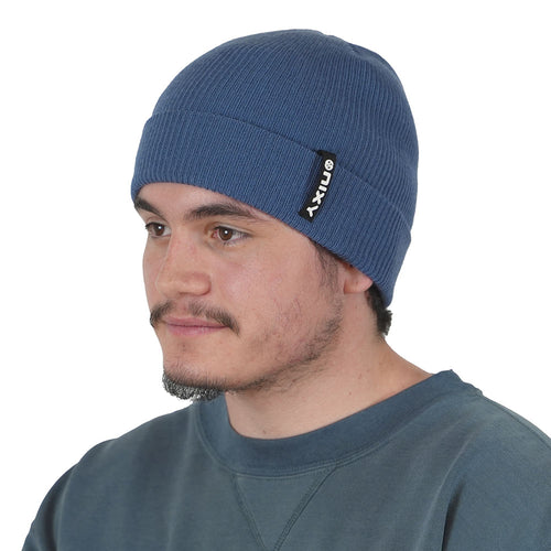 Young man wearing navy blue NIXY Sports classic cuffed knit beanie, men's winter hat for paddleboarding, fishing, and cold-weather outdoor sports