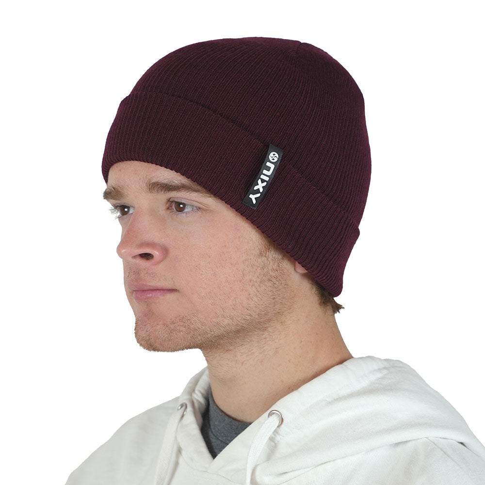 Man wearing merlot maroon NIXY Sports classic cuffed knit beanie with white hoodie – men's ribbed winter hat for casual and cold-weather outdoor wear