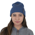 Woman wearing navy blue NIXY Sports classic cuffed knit beanie – women's winter hat paired with gray zip-up sweatshirt for casual cold-weather style