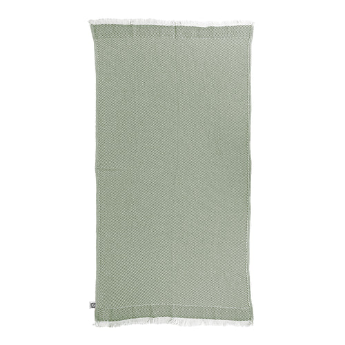 Green textured Turkish cotton beach towel with frayed edges on a white background