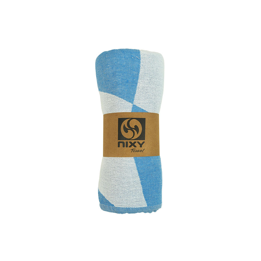 NIXY Squares Recycled Turkish Beach Towel in Bright Blue rolled and styled on a white background