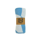 NIXY Squares Recycled Turkish Beach Towel in Bright Blue rolled and styled on a white background