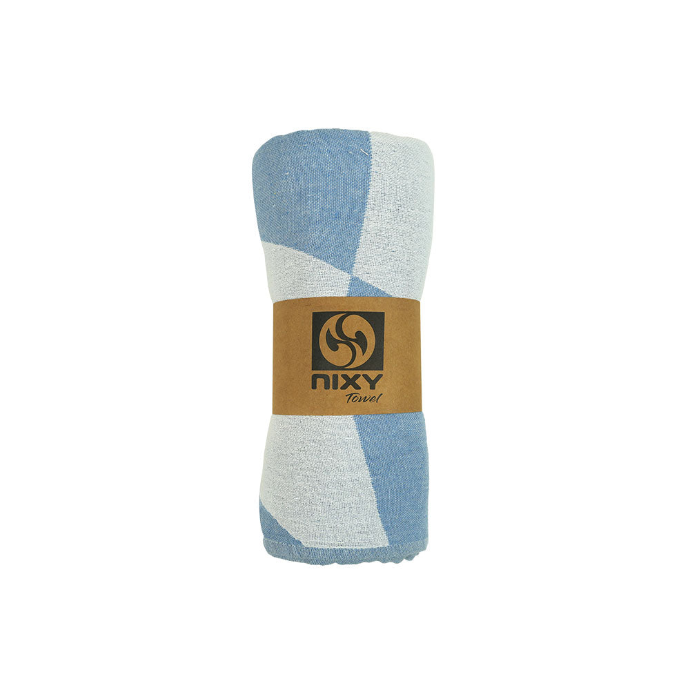 NIXY Squares Recycled Turkish Beach Towel in Light Blue rolled and styled on a white background