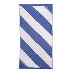 NIXY Parallax Recycled Turkish Cotton Beach Towel (Blue). A rectangular beach towel with bold diagonal stripes in blue and white, shown flat against a white background.