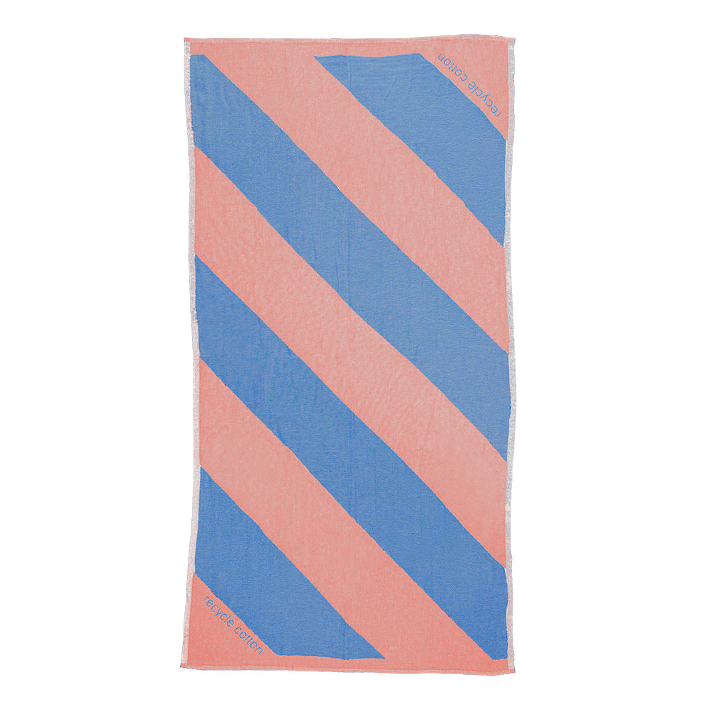 NIXY Parallax Recycled Turkish Cotton Beach Towel (Coral Blue). A rectangular beach towel with bold diagonal stripes in light blue and pink, shown flat against a white background.
