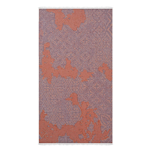 A product photo of a Turkish cotton beach towel with symmetrical patterns in front of a white background.