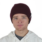 Man wearing merlot maroon NIXY Sports skull beanie with white hoodie – men's slouchy uncuffed winter hat for casual and cold-weather outdoor wear