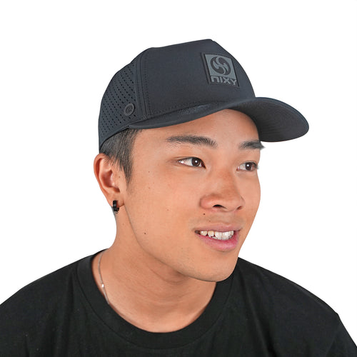 NIXY Stoked Trucker Water Hat in black with breathable mesh back and curved brim for sun protection during paddleboarding