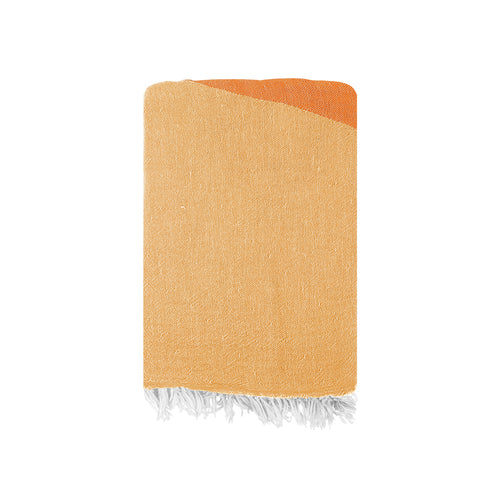 Yellow and orange Turkish cotton beach towel with white fringe on a white background