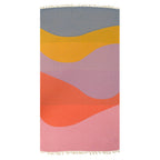 Colorful Turkish cotton beach towel with wavy pattern on a white background