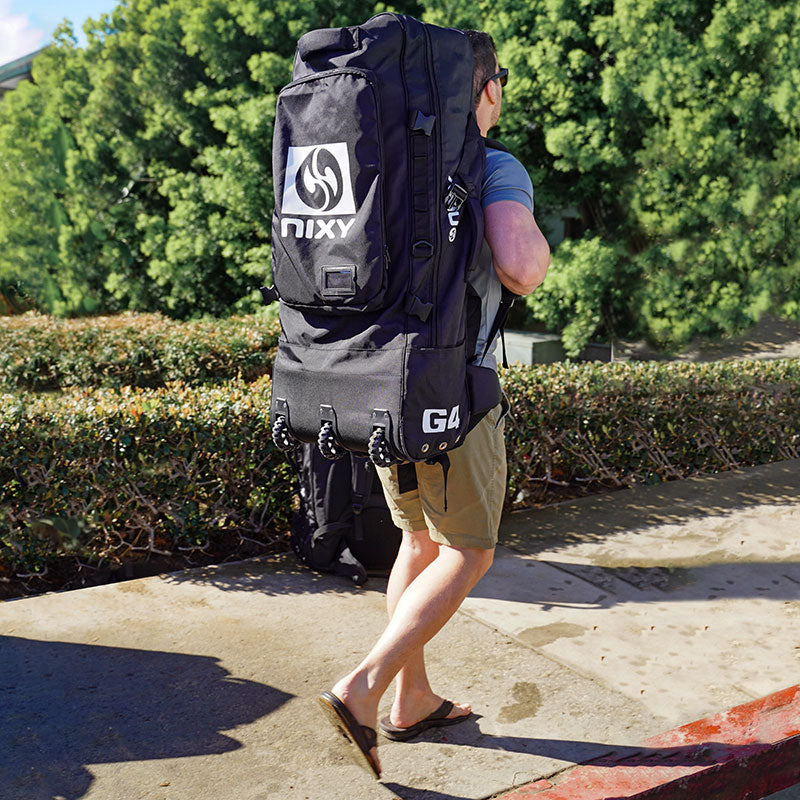 A man walking on the sidewalk carrying a nixy isup backpack on his shoulders