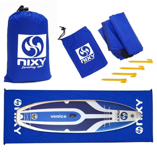 NIXY Landing Mat in Blue set showing carry bag, folded mat, yellow ground stakes and NIXY Venice paddleboard laid on unfolded mat, lightweight waterproof ripstop nylon ground cover with NIXY sports logo for paddleboarding, SUP and beach gear protection