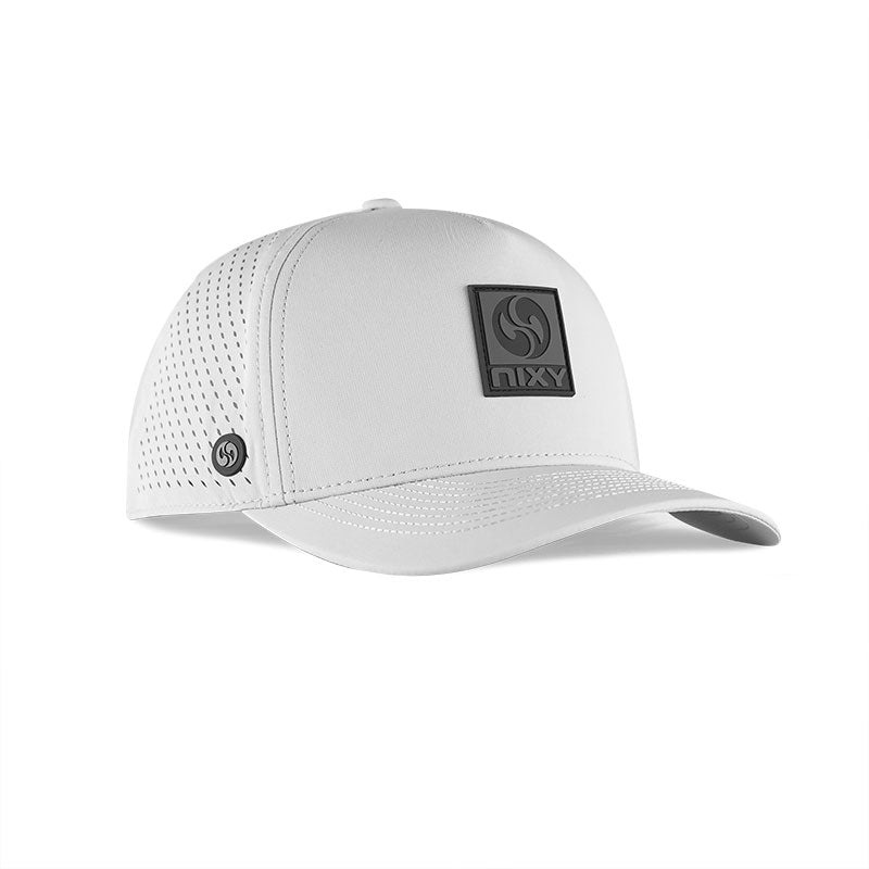 NIXY Stoked Trucker Water Hat in white angled view showing structured crown and black NIXY logo patch