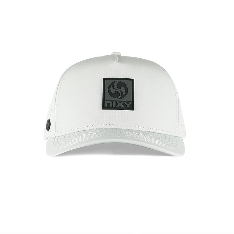 NIXY Stoked Trucker Water Hat in white front view featuring black embossed NIXY rubber logo patch and curved brim