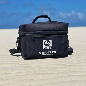 Carrying bag for electric pump placed on the sand of a beach